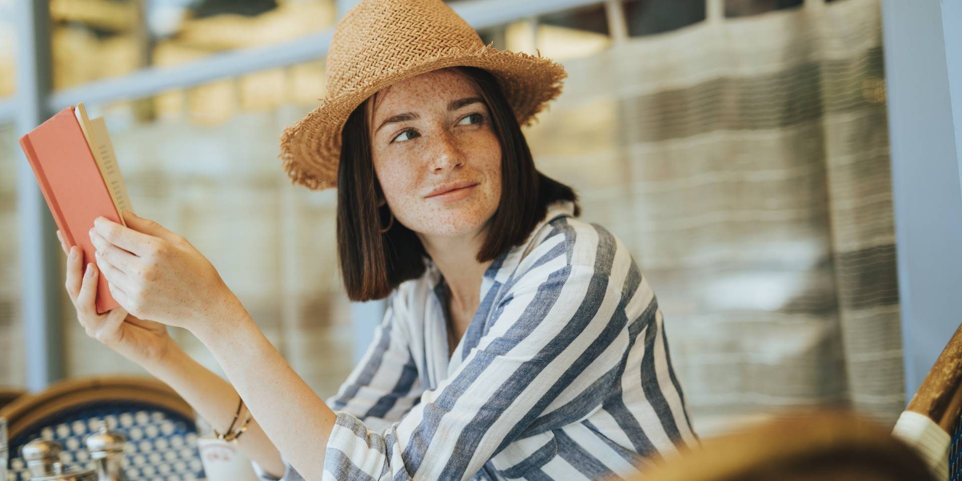 Woman reading a book at a cafe